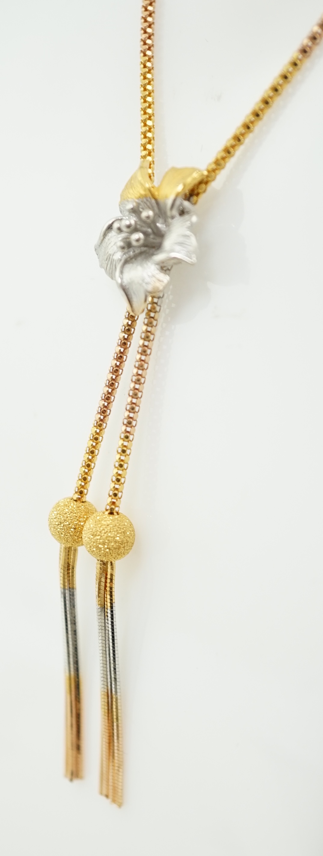 A recent Middle Eastern three colour 22k gold tassel drop necklace and pair of matching drop earrings